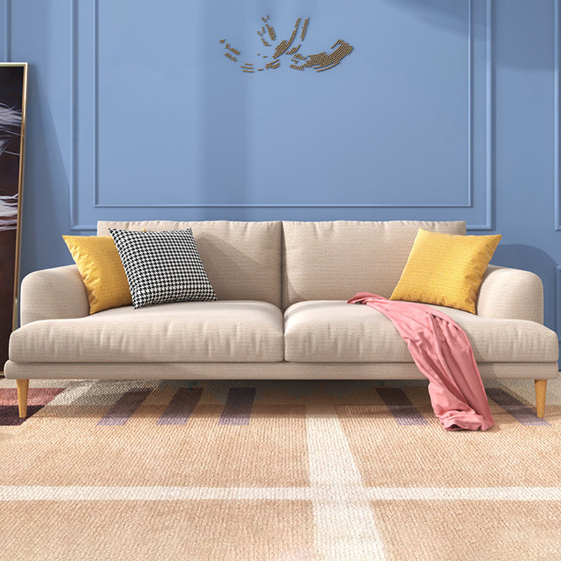 Salle de salon à armoine en retrait standard canapé beige moderne