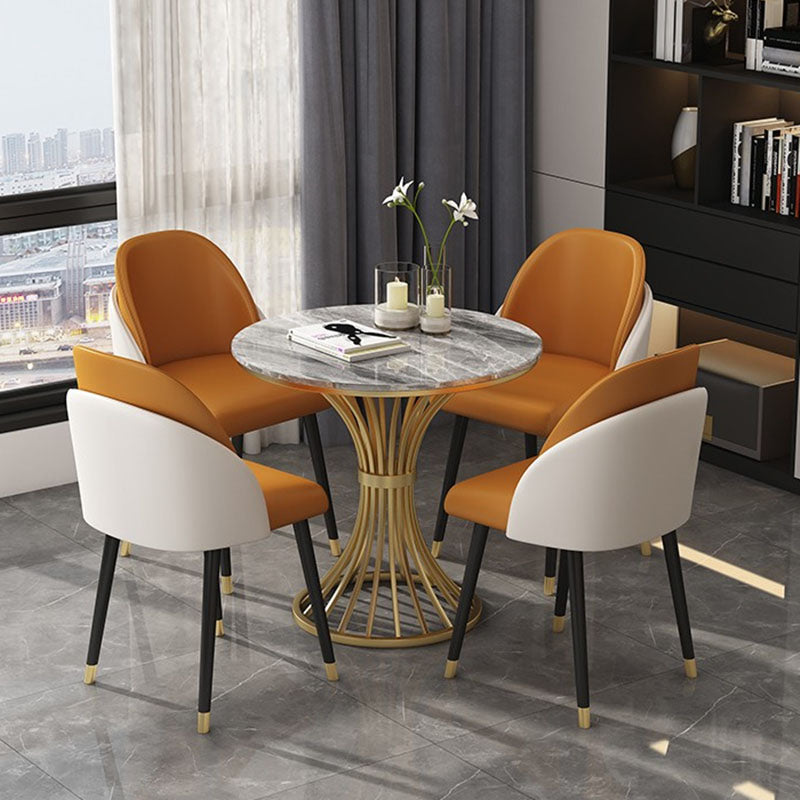 Table à manger de luxe traditionnelle Table ronde en pierre frittée avec base dorée