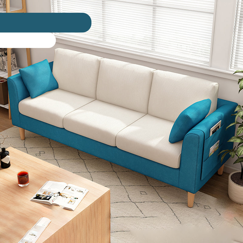 Canapé scandinave de 3 places avec oreillers en dos et bras de smoking et pattes en bois massif