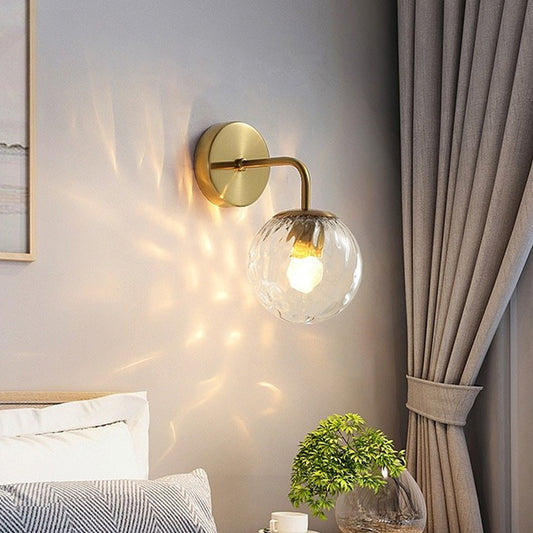 Ball Shaped Wall Lamp Minimalist Clear Rippling Glass 1-Light Bedroom Wall Mounted Lighting with Bent Arm in Black/Gold Gold Clearhalo 'Cast Iron' 'Glass' 'Industrial' 'Modern wall lights' 'Modern' 'Tiffany' 'Traditional wall lights' 'Wall Lamps & Sconces' 'Wall Lights' Lighting' 1936626