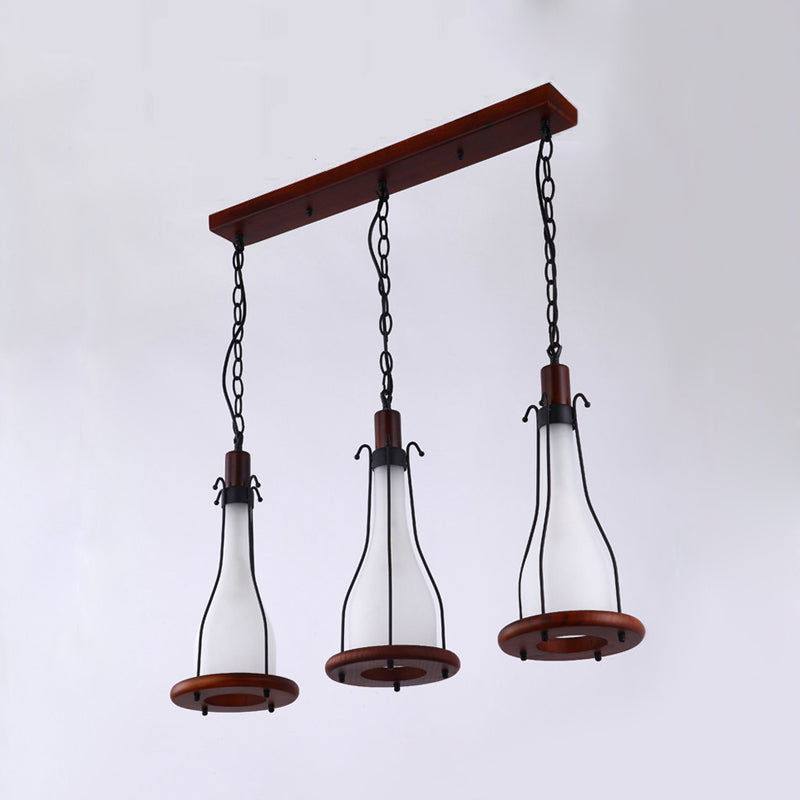 Brown Bottle Cluster Pendant Light Warehouse Yellow/White Glass 3 Heads Dining Room Ceiling Fixture with Wood Linear Canopy Clearhalo 'Art Deco Pendants' 'Cast Iron' 'Ceiling Lights' 'Ceramic' 'Crystal' 'Industrial Pendants' 'Industrial' 'Metal' 'Middle Century Pendants' 'Pendant Lights' 'Pendants' 'Tiffany' Lighting' 736183