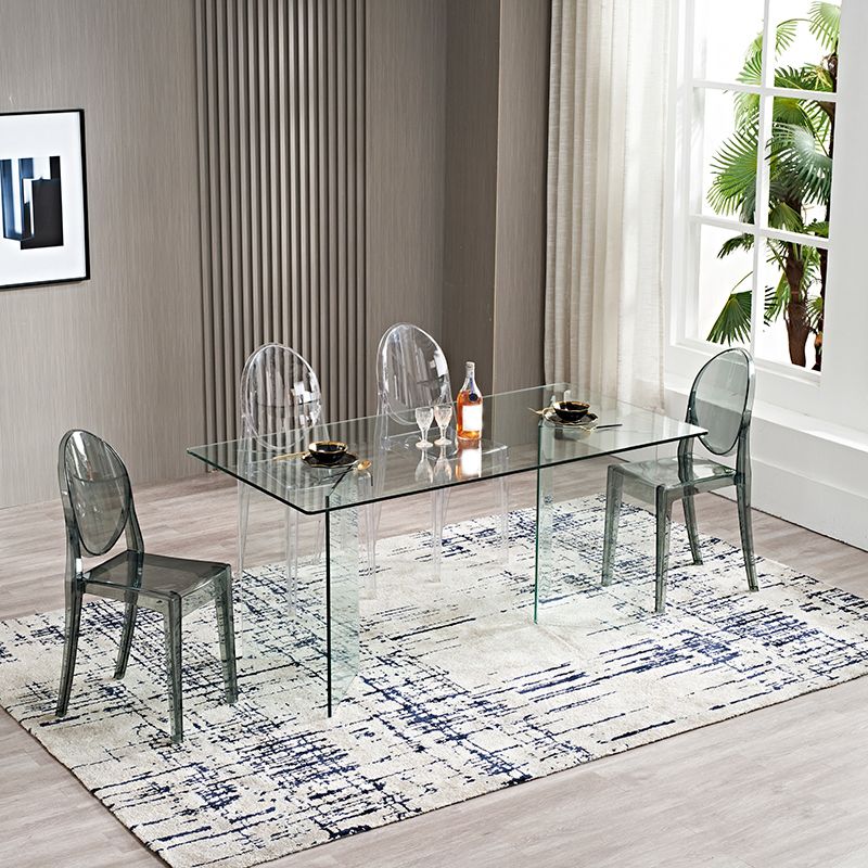 Moderne rechthoekige eettafel met glazen blad en dubbel voetstuk