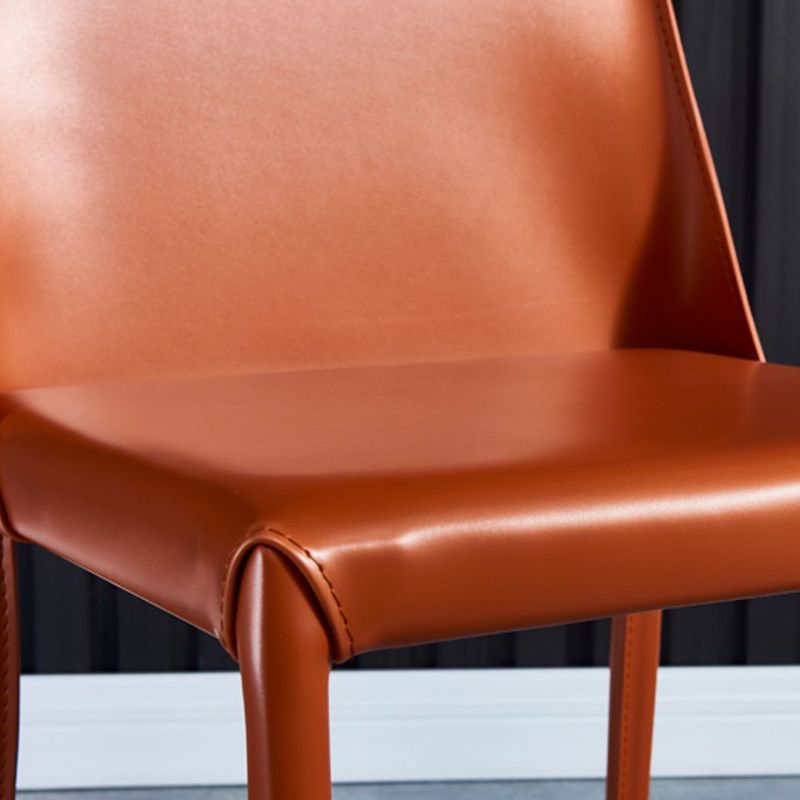 Eigentijdse metalen eetkamerstoel faux lederen armloze eetkamerstoel voor thuisgebruik