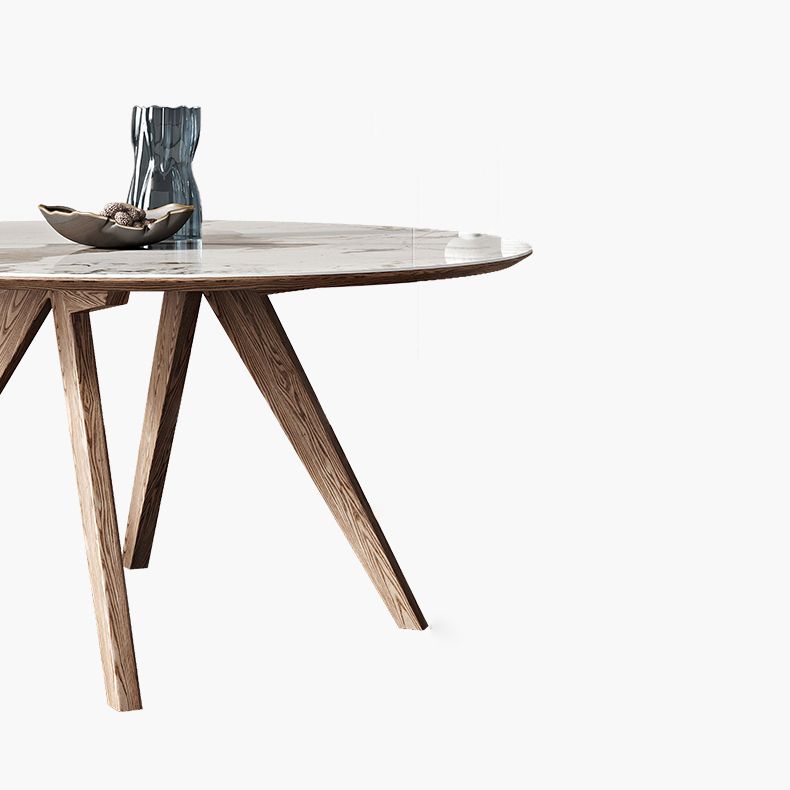 Witte gesinterde stenen tafel rond huiskeukendiner met natuurlijke poten