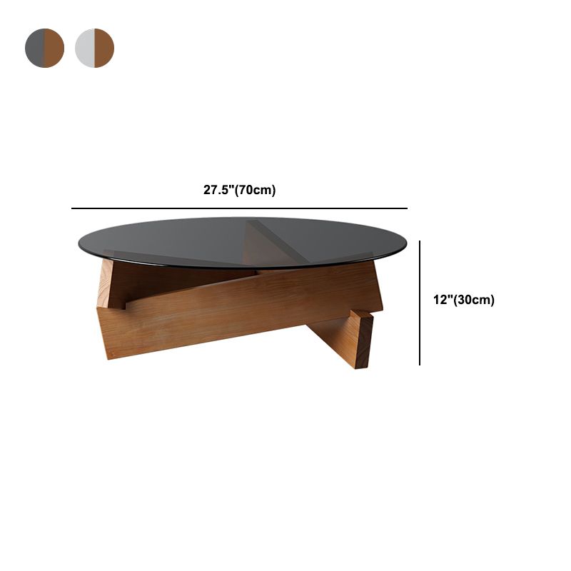 Moderner runder Couchtisch mit Glasplatte und abstraktem Holzbein