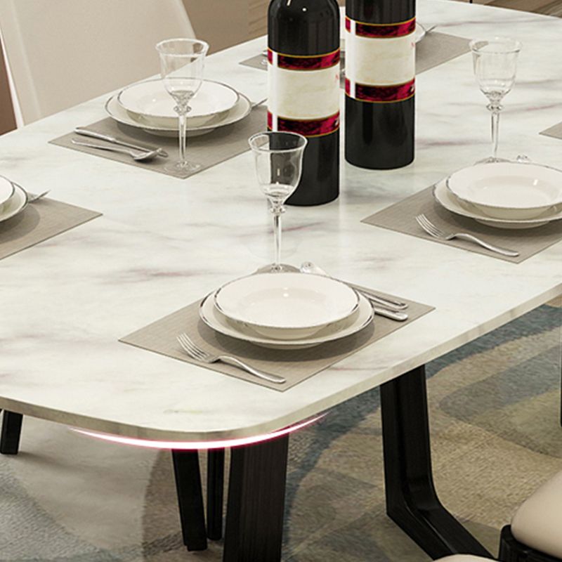Mesa de comedor blanca de piedra rectangular moderna con base de caballete negro de cenizas