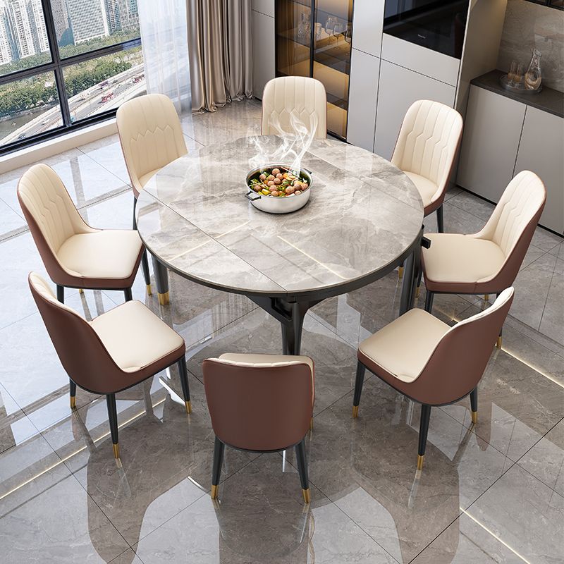 無地の木製の脚のある現代の丸い灰色の石のダイニングテーブル