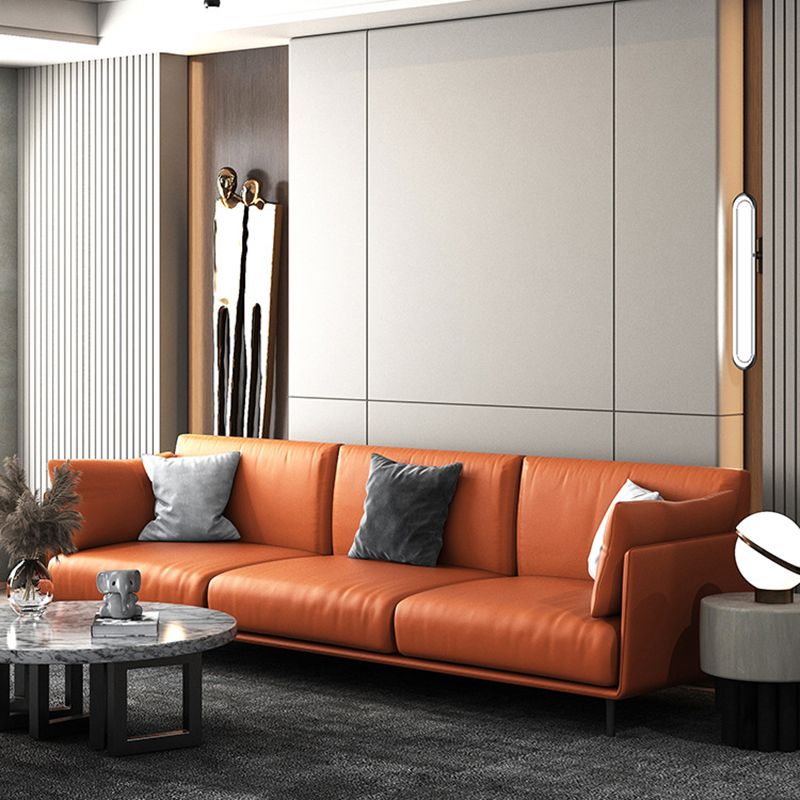 Divano con divano arancione in finta pelle cuscino con gambe metalliche