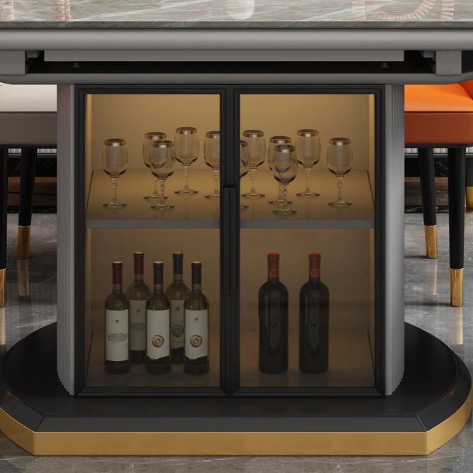 Moderne uitschuifbare eettafel rond stenen tafelblad met opbergruimte