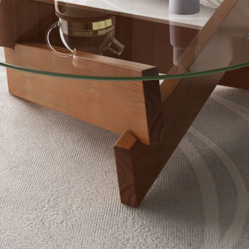 Moderner runder Couchtisch mit Glasplatte und abstraktem Holzbein