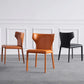 Silla lateral de ala de silla de comedor de cuero contemporánea en acabado mate con patas de acero