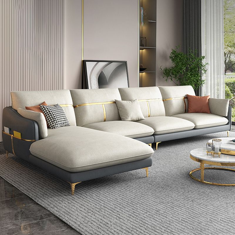 Divano sezionale in vetro in finta in finta pelle grigio a forma di l braccio inclinata