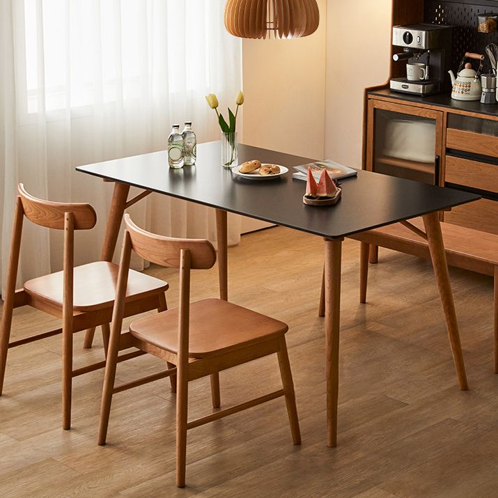Table de salle à manger rectangulaire moderne avec plateau en pierre noire et 4 pieds en bois massif