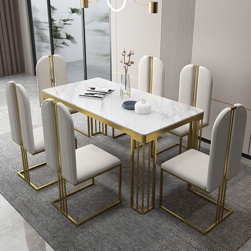Esstisch im Glam-Stil mit Steinplatte und goldenem Sockel für das Wohnzimmer
