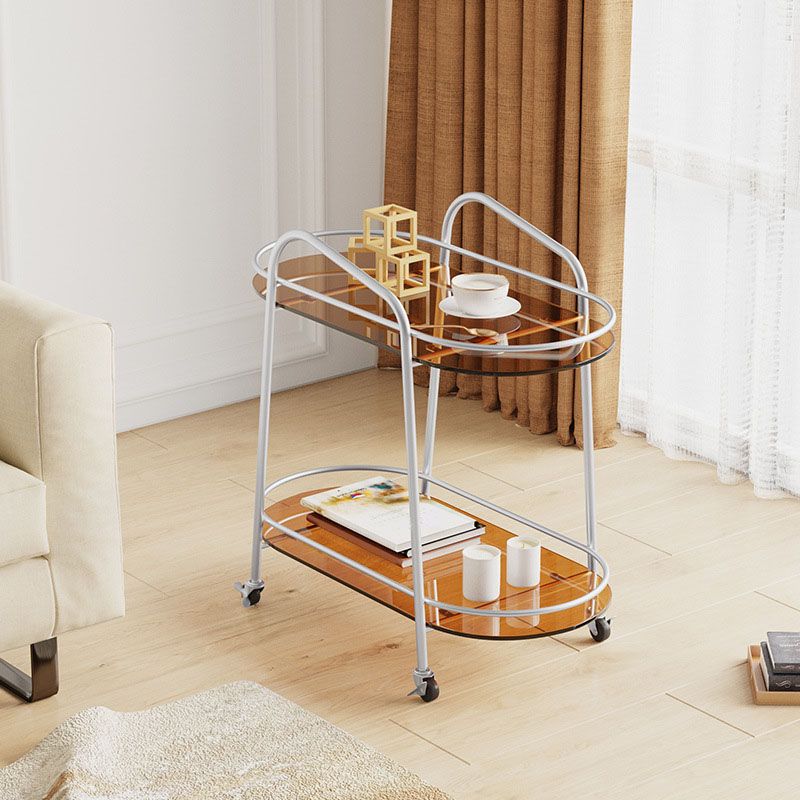 棚と車輪付きのモダンな楕円形のガラスサイドテーブルエンドテーブルメタルベースサイドテーブル