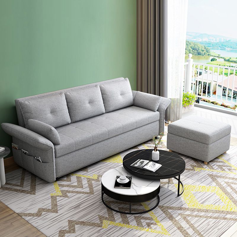 Sleeper de tela moderna en un futón de brazo acampanado gris claro y colchón con almacenamiento