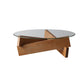 Moderner runder Couchtisch mit Glasplatte und abstraktem Holzbein