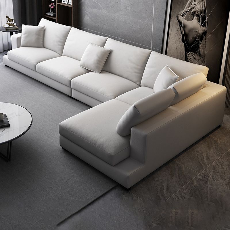 Sectionele zitbank met stoffen kussen en vierkante arm in grijs