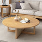 Tavolino scandinavo rotondo con gambe incrociate in legno di pino