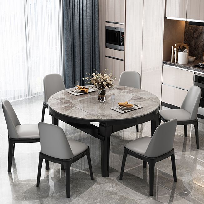 Moderner runder graues Steinoberteil ausziehbar einziehbarer Esstisch mit 4 schwarzen Beinen mit Gummiholzbeinen