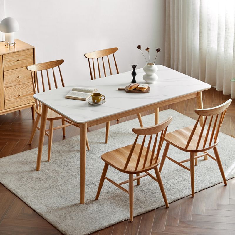 Moderne massief houten poten eettafel met rechthoekig stenen blad