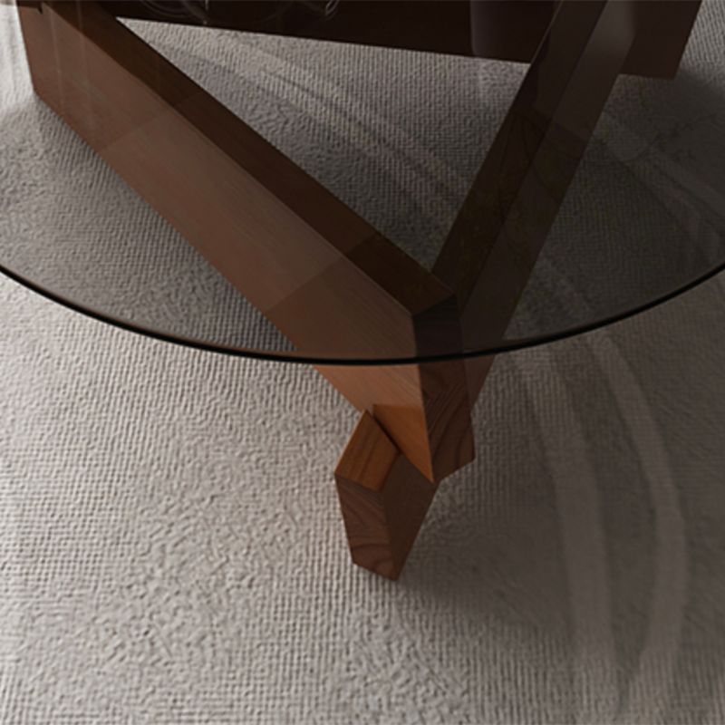 Moderner runder Couchtisch mit Glasplatte und abstraktem Holzbein