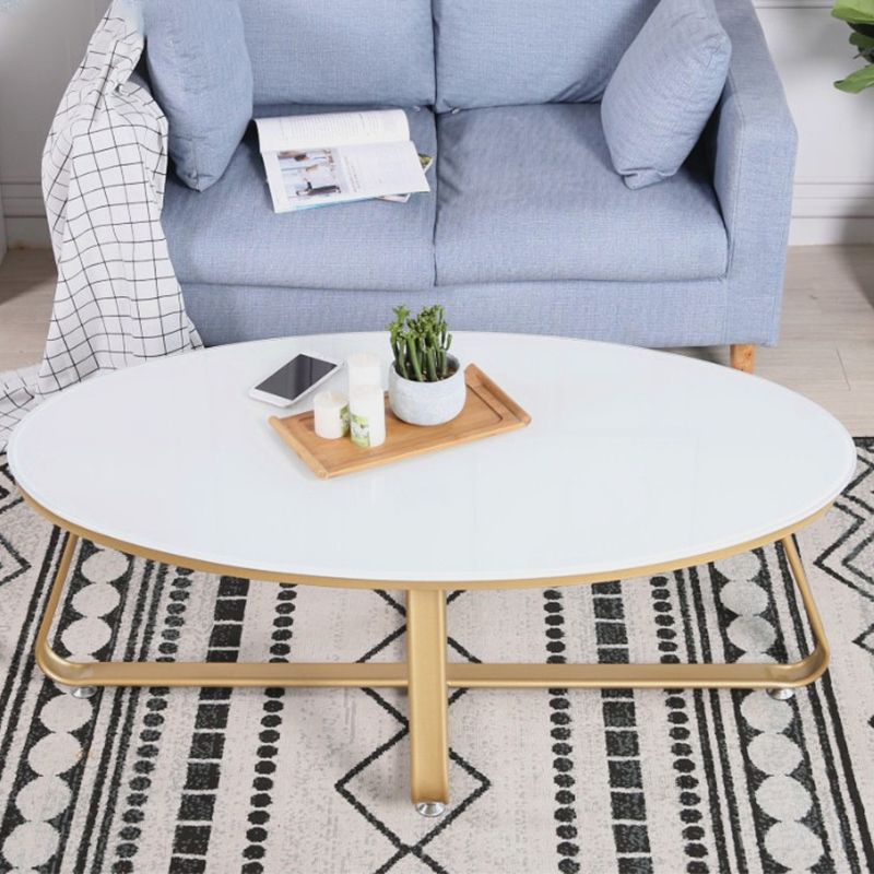 Glam Style Cocktail Table with Oval Top and Golden Iron Cross Base