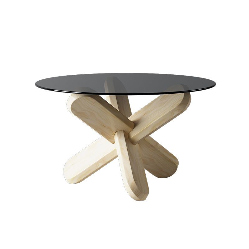 Moderner runder Couchtisch mit Glasplatte und abstraktem Holzbein