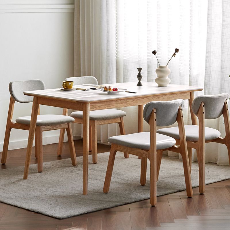 Moderne massief houten poten eettafel met rechthoekig stenen blad