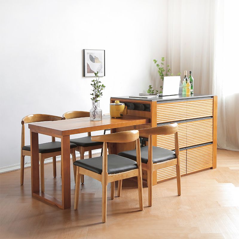 Mesa de cocina moderna de piedra negra con base de madera sólida y cajones