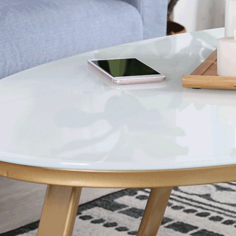 Glam Style Cocktail Table with Oval Top and Golden Iron Cross Base