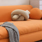 Canapé-lit orange avec dos serré et bras carrés en faux cuir