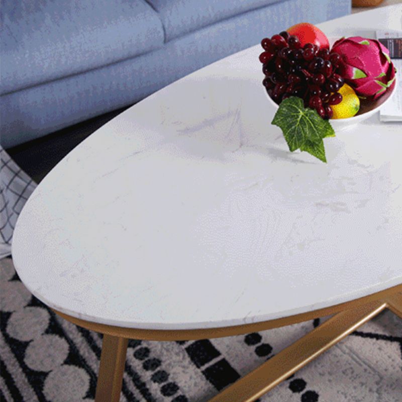 Glam Style Cocktail Table with Oval Top and Golden Iron Cross Base