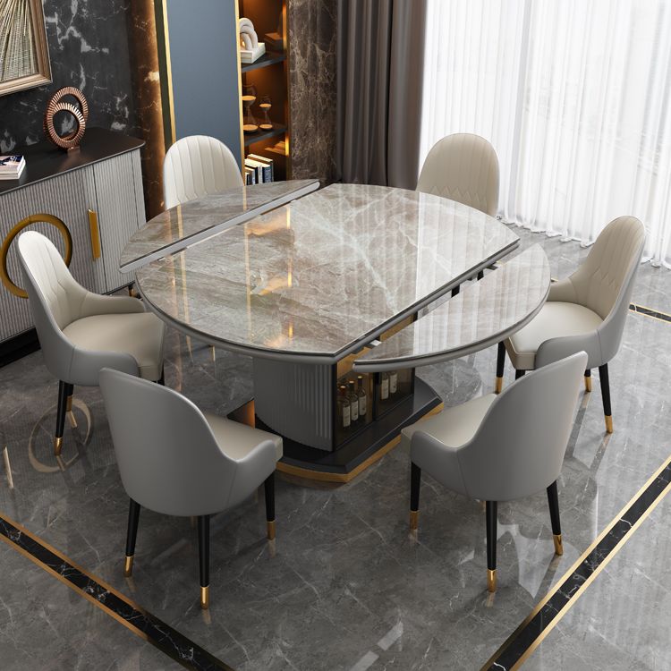 Moderne uitschuifbare eettafel rond stenen tafelblad met opbergruimte