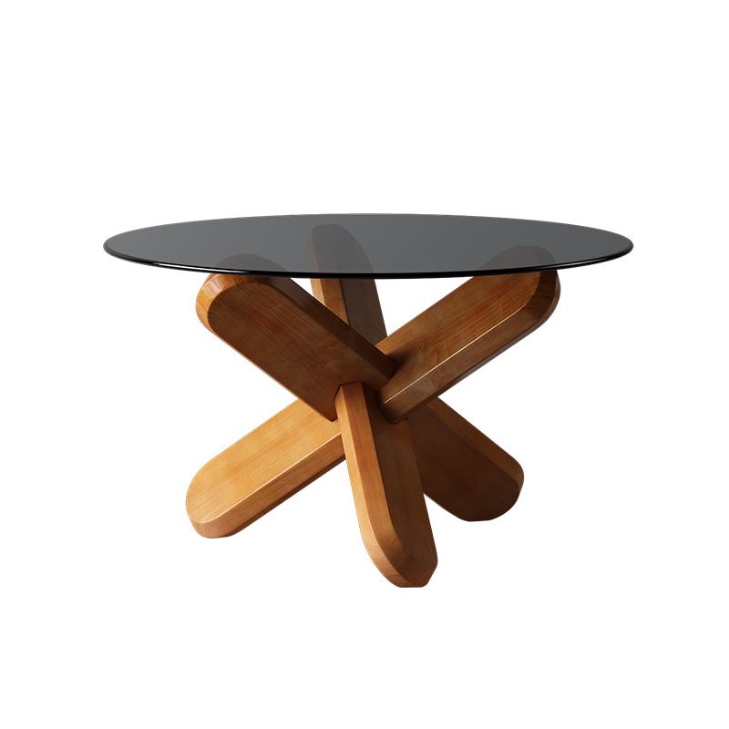 Moderner runder Couchtisch mit Glasplatte und abstraktem Holzbein