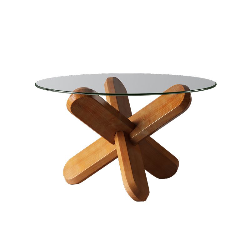 Moderner runder Couchtisch mit Glasplatte und abstraktem Holzbein