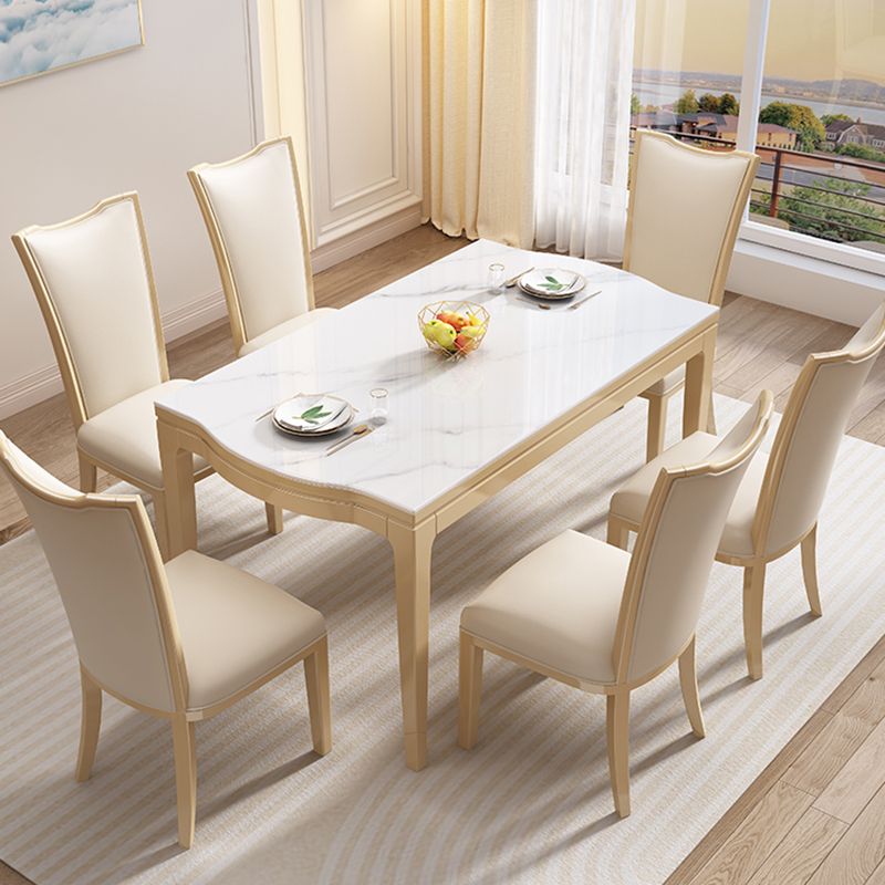 Table à manger moderne en pierre blanche avec pieds en bois massif pour le salon