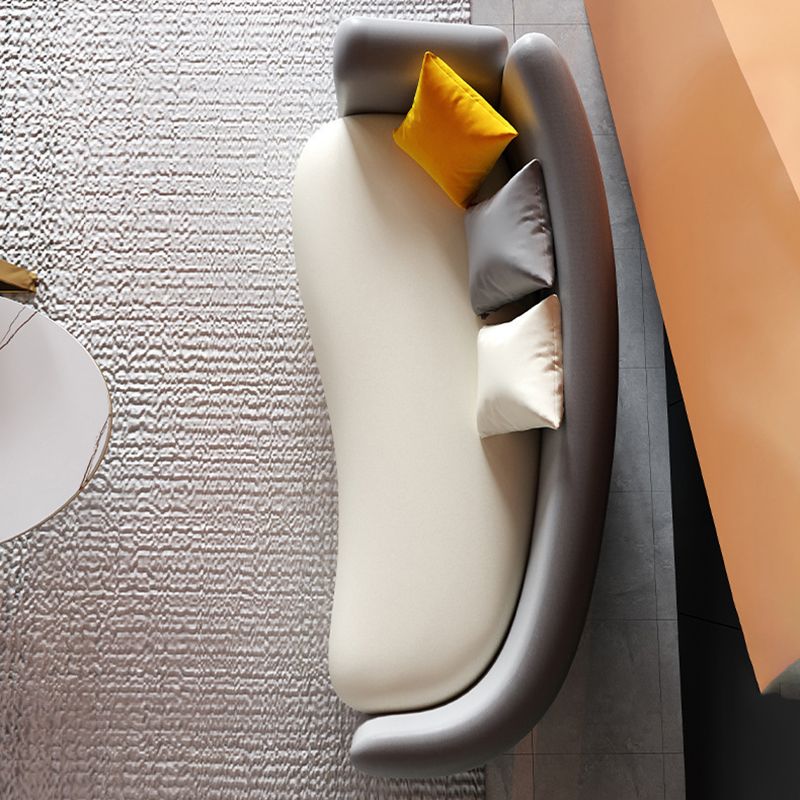 Sofa incurvé au dos serré contemporain avec oreiller, canapé de bras de smoking en cuir