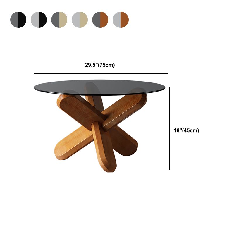 Moderner runder Couchtisch mit Glasplatte und abstraktem Holzbein