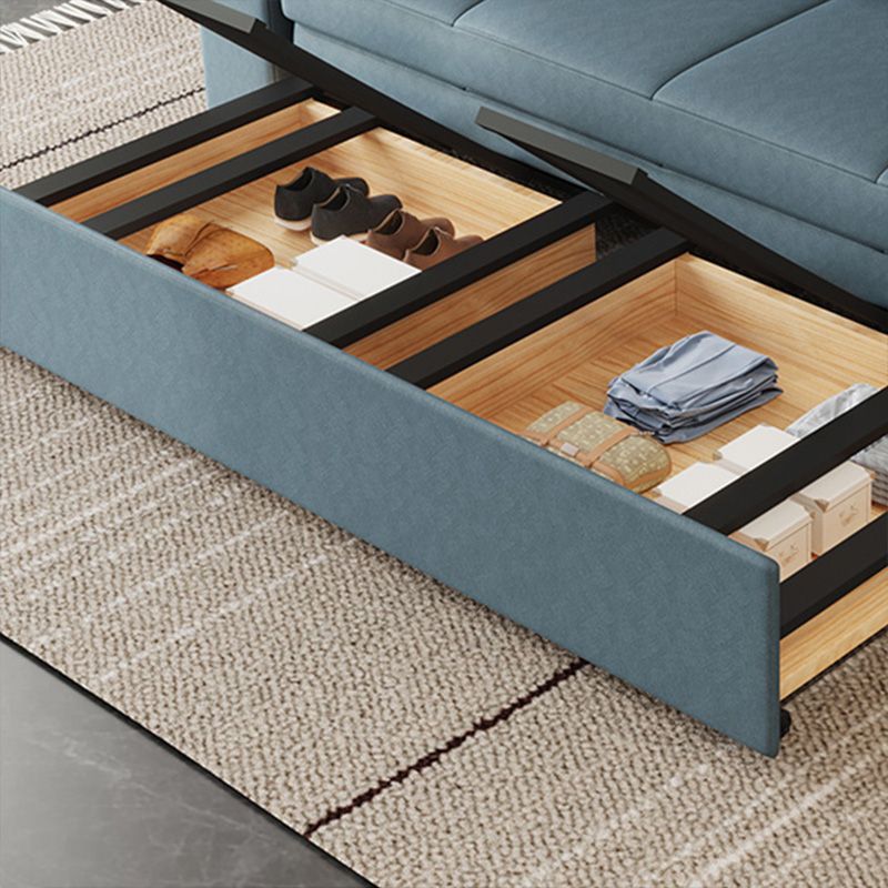 Canapé-lit bleu scandinave avec rangement et coussin en arrière