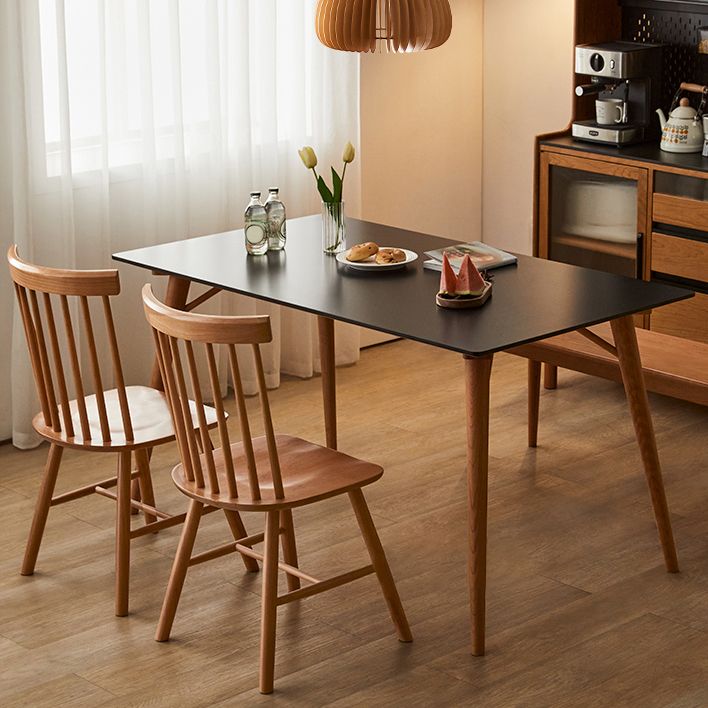 Table de salle à manger rectangulaire moderne avec plateau en pierre noire et 4 pieds en bois massif