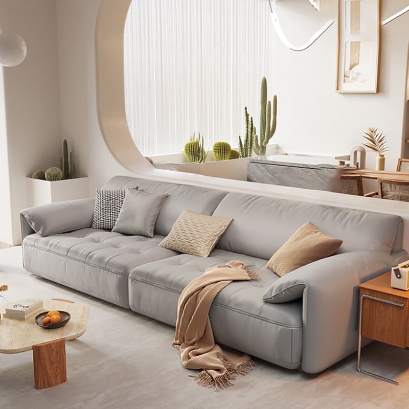 Sofá seccional con brazo superior tipo almohada en madera maciza con respaldo acolchado