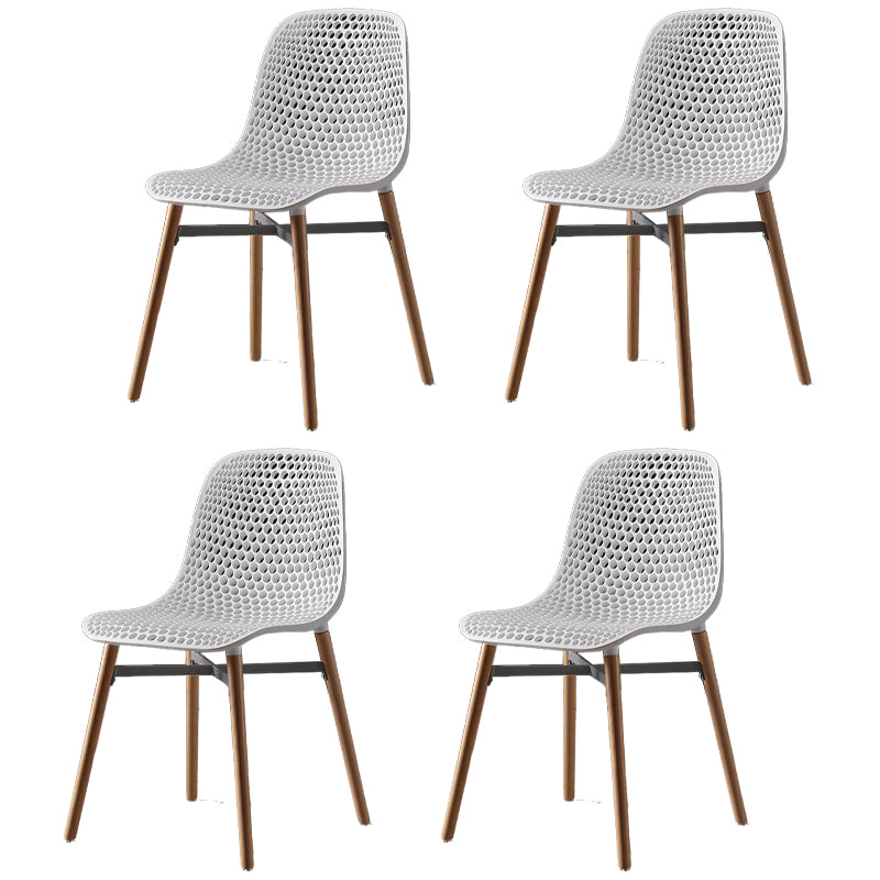 Scandinavian Style Plastic Dining Armless Chair Solid Back Chair with Wooden Legs White 4 Piece Set Clearhalo ' kitchen&dining_furn' 'Dining Chairs' 'Dining Tables & Seating' 'dining_chair' 'furn' 'furn_dining_chair' 'Furniture' 'furniture_dining_chair' 'Kitchen & Dining Furniture' 'kitchen' 4039138