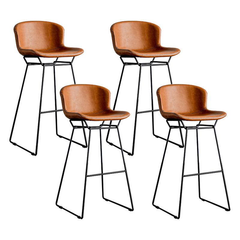 Taburete de barra de hierro industrial en la parte baja de la espalda en interiores altos con asiento de cuero falso