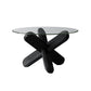 Moderner runder Couchtisch mit Glasplatte und abstraktem Holzbein
