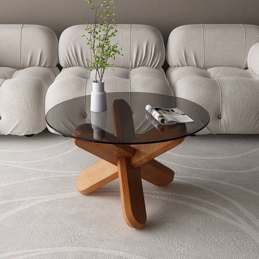 抽象的な木製の脚を備えたモダンな丸いガラスのトップコーヒーテーブル