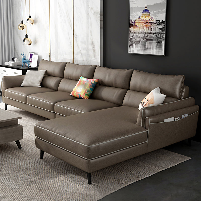 Sectionnel en faux cuir en L avec bras encastrés et rangement