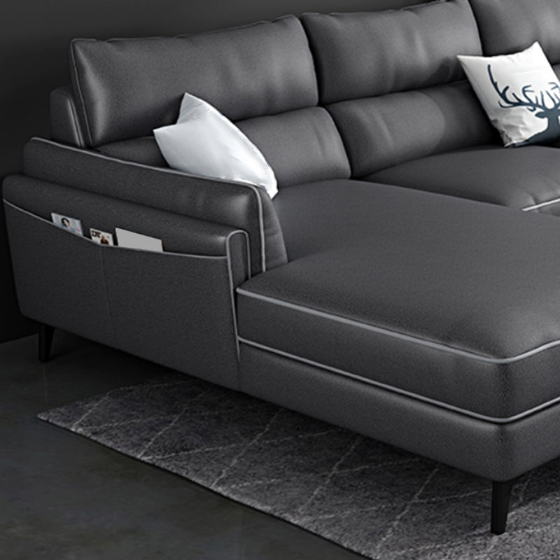 Sectionnel en faux cuir en L avec bras encastrés et rangement