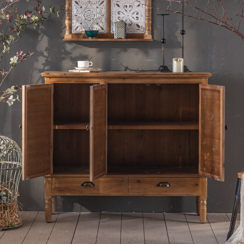 Gabinete de madera industrial con patas y cajones girados en marrón