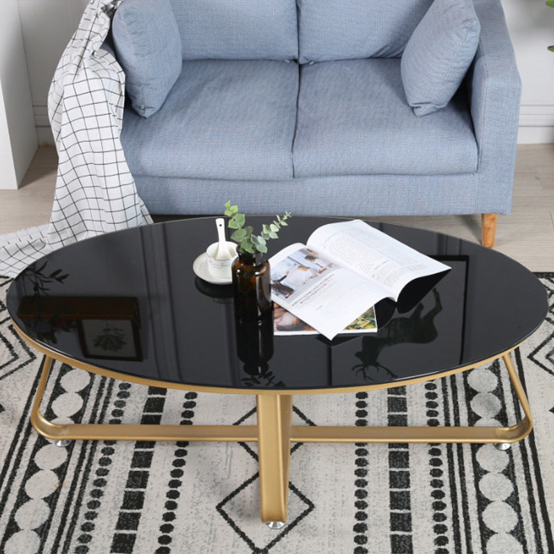Glam Style Cocktail Table with Oval Top and Golden Iron Cross Base